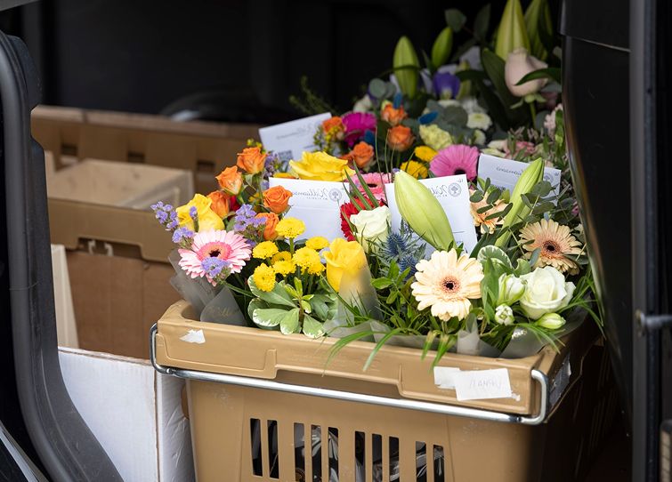 Crate of freshly prepared flower bouquets ready for local flower delivery in Scotland