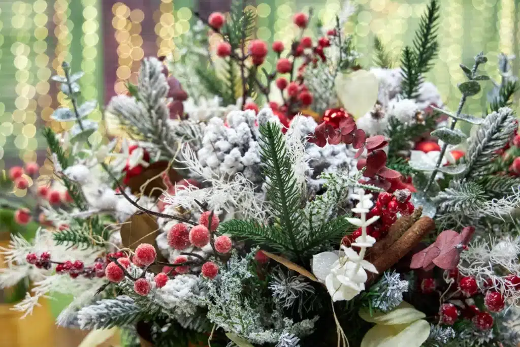 Array of festive foliage including pine, red berries, pine cones, and eucalyptus