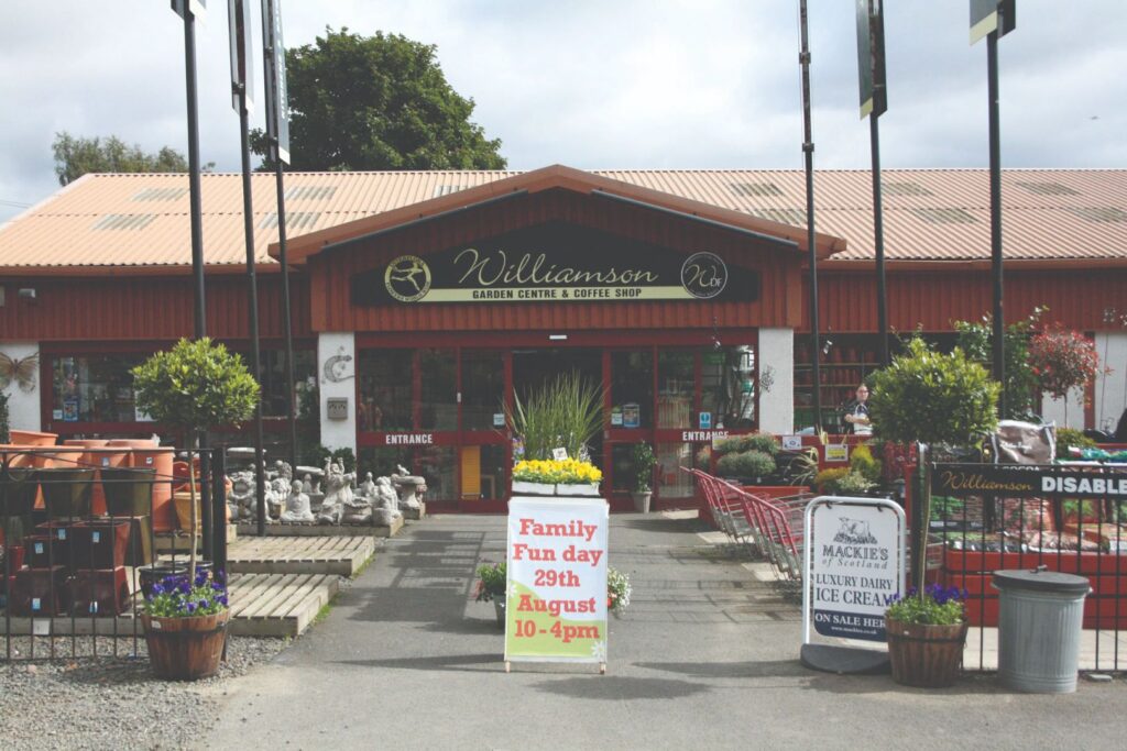 Exterior of Williamson's Garden Centre and Coffee Shop in Livingston with entrance, garden ornaments and seasonal plants outside