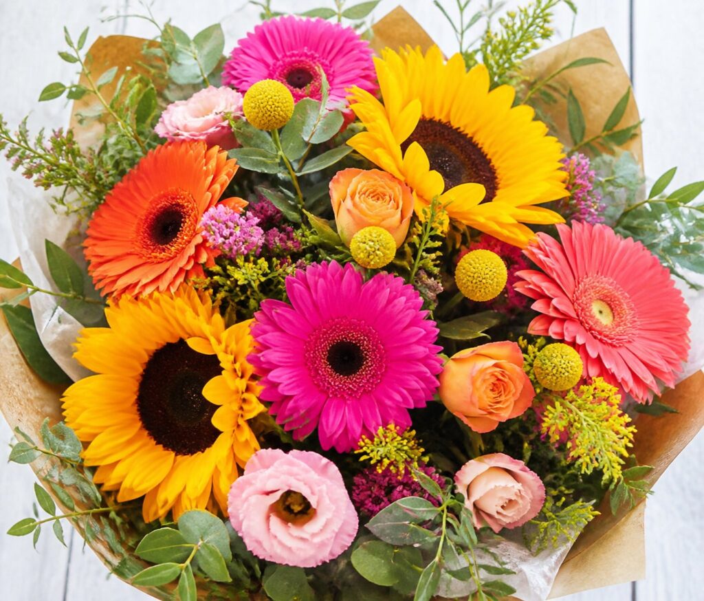 Fresh flowers for sister bouquet including bright gerberas and sunflowers.