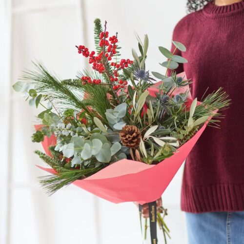 Festive Foliage bouquet with winter greenery, red berries and natural cones